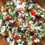 greek salad with chopped romaine, grape tomatoes, cucumber, kalamata olives, and feta