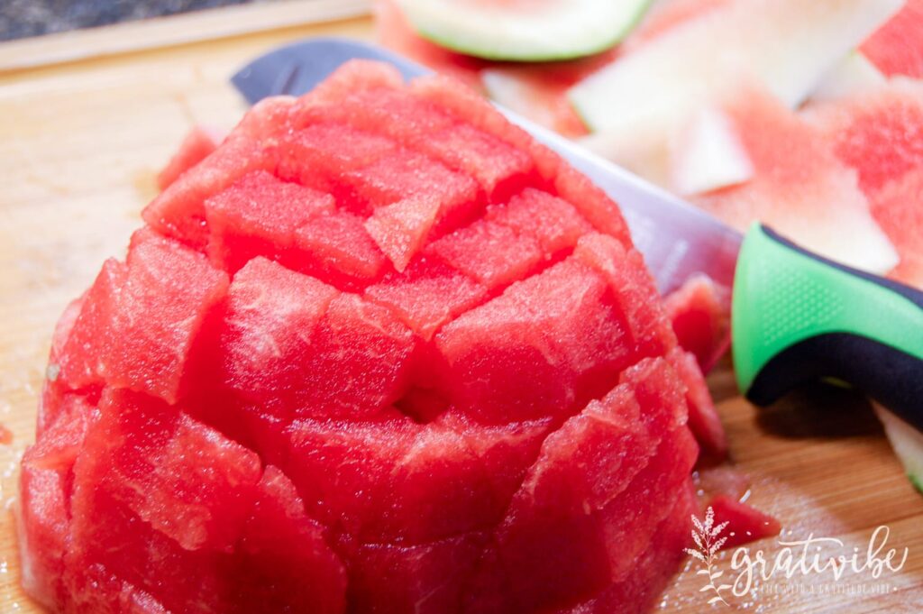 half watermelon with rind removed and cubed