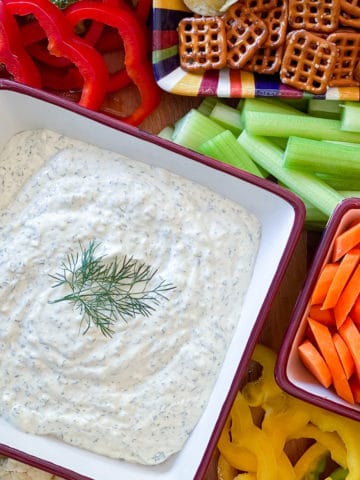 vegetable dip on tray with assorted vegetables and pretzels