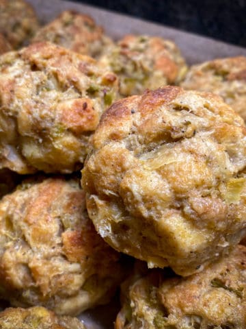 baked stuffing balls stacked on sheet pan