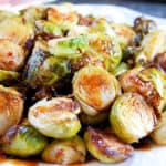 roasted brussels sprouts halves drizzled in chili glaze