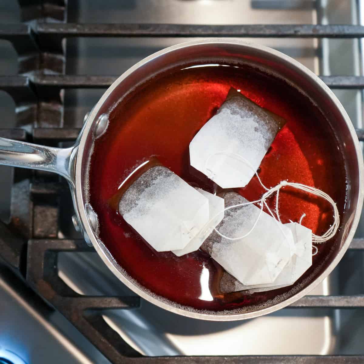 two cups of water in small saucepan with suga