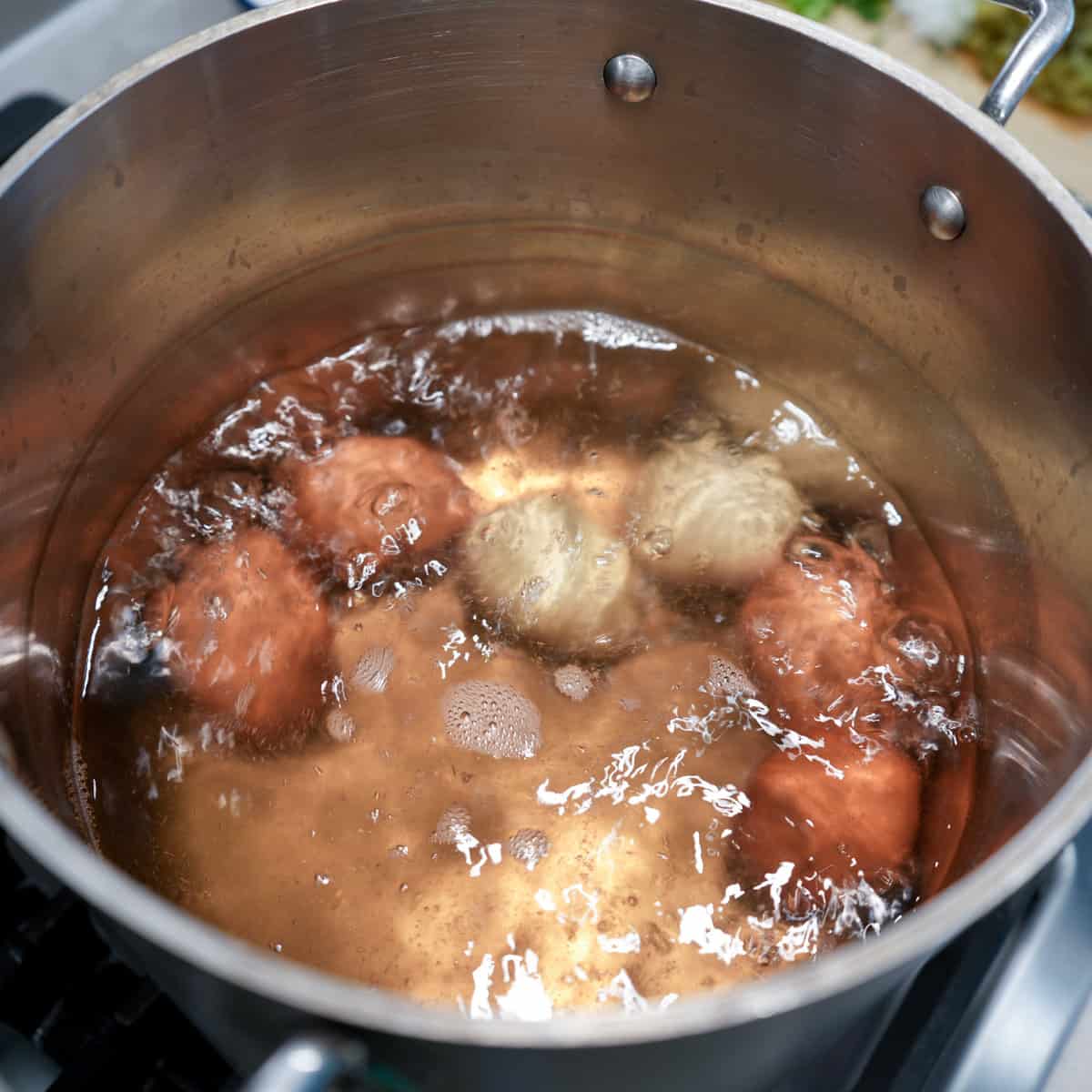 six eggs in pot of boiling water
